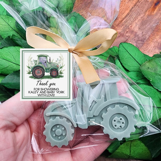 a hand holding a card with a tractor on it