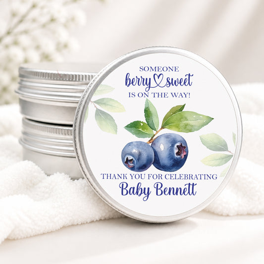Personalized blueberry baby shower candle favor in a silver tin featuring watercolor blueberries and the phrase "Someone Berry Sweet Is On The Way" with custom baby shower personalization.