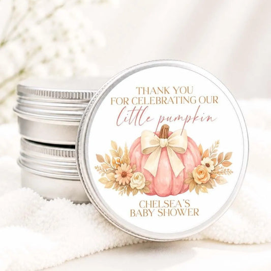 A round tin lid with a label that says "Thank you for celebrating our little pumpkin Chelsea's baby shower" and features an illustration of a pumpkin with flowers.