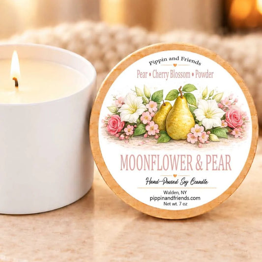 a white candle with a floral design and a wooden lid, placed next to a white candle holder on a table.