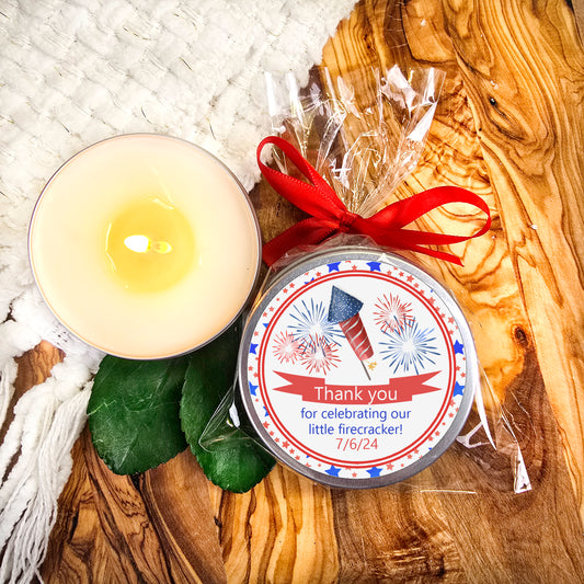 a candle with a ribbon around it on a table