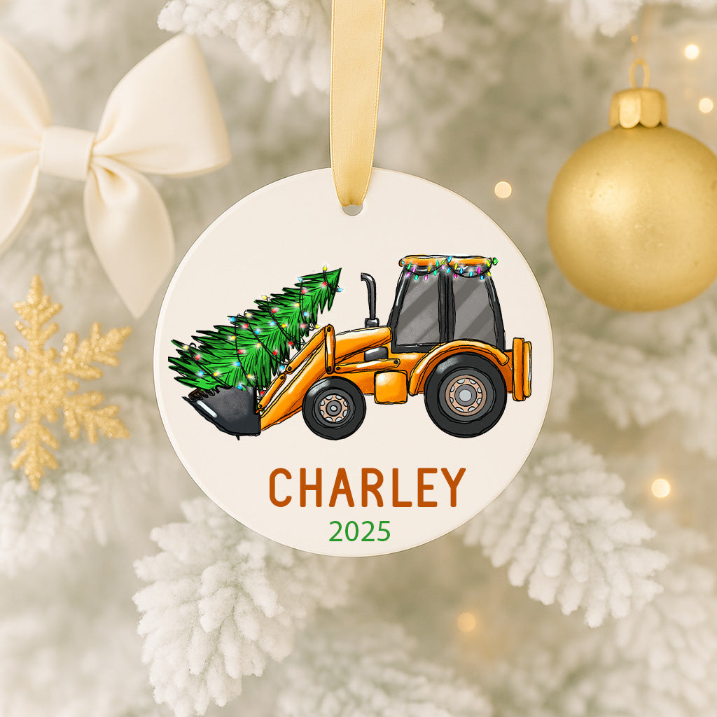 A Christmas ornament featuring a tractor carrying a Christmas tree, with the name "Charley" and the year "2025" printed on it.
