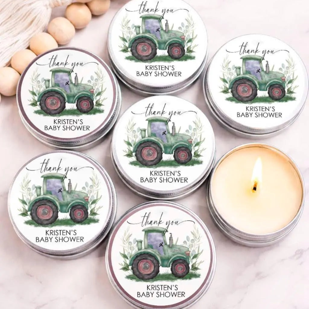 six silver tin candle holders with a green tractor design and the text "Thank you" printed on them. There is also a single candle in one of the candle holders.