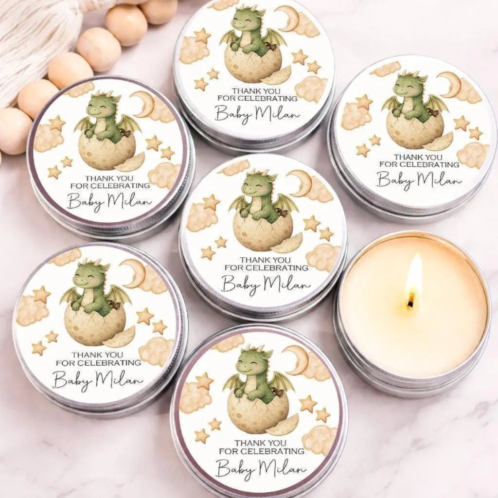 a collection of round tin candles with dragon illustrations and text, arranged on a marble surface.