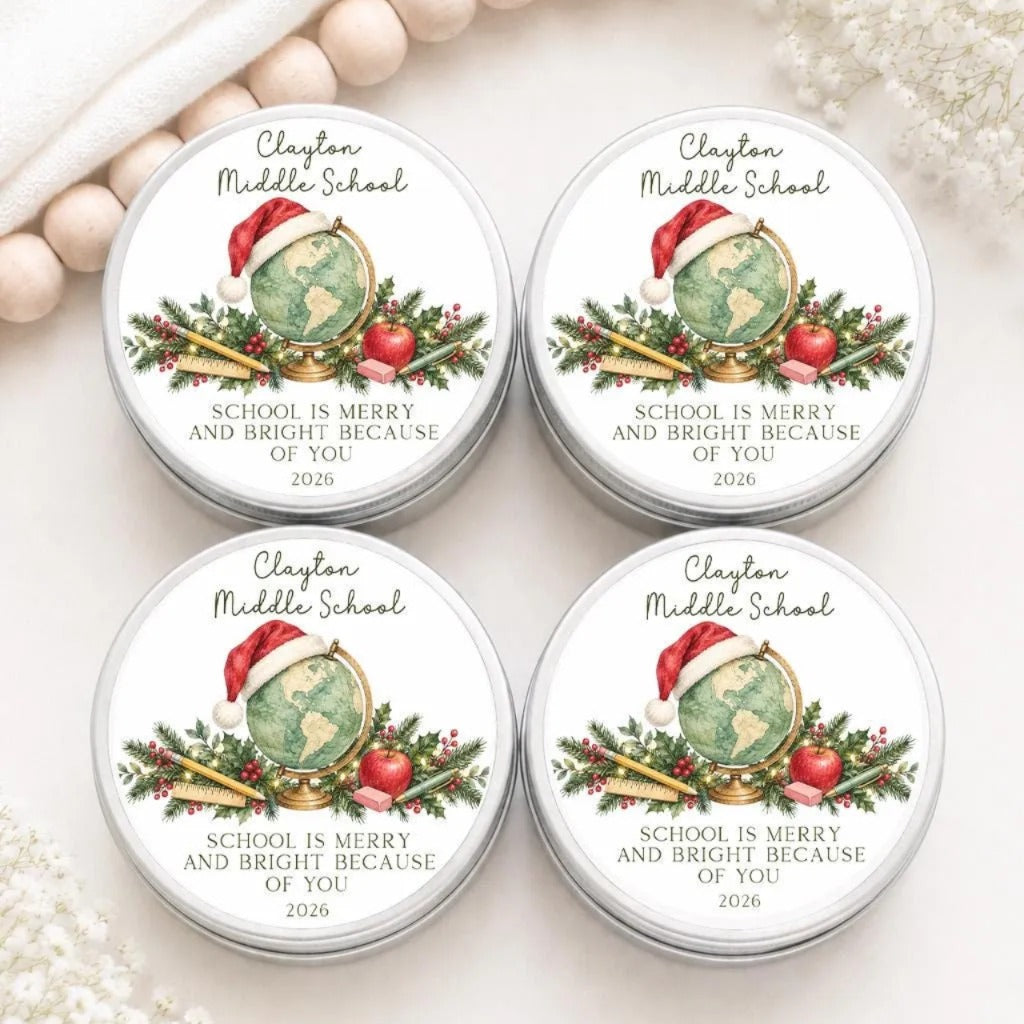 four tin labels with a festive design, featuring a globe, a Santa hat, and holiday decorations such as berries and an apple. The labels are for Clayton Middle School and are intended to be used as gifts or mementos.