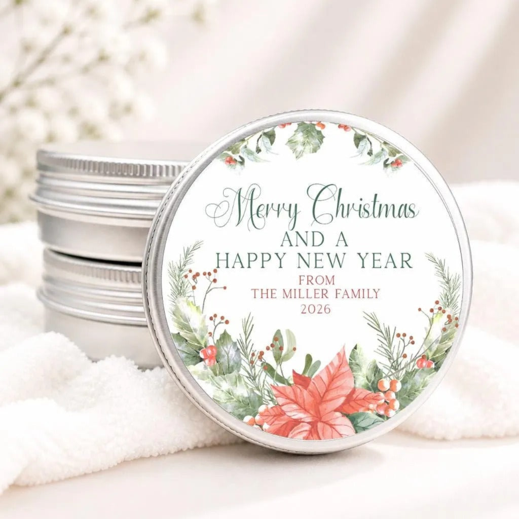 A round tin lid with a festive holiday message, placed on a white cloth.