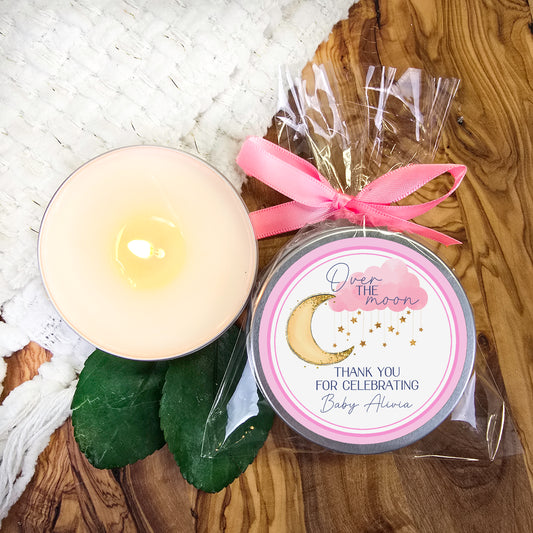 a candle and a package of chocolates on a table