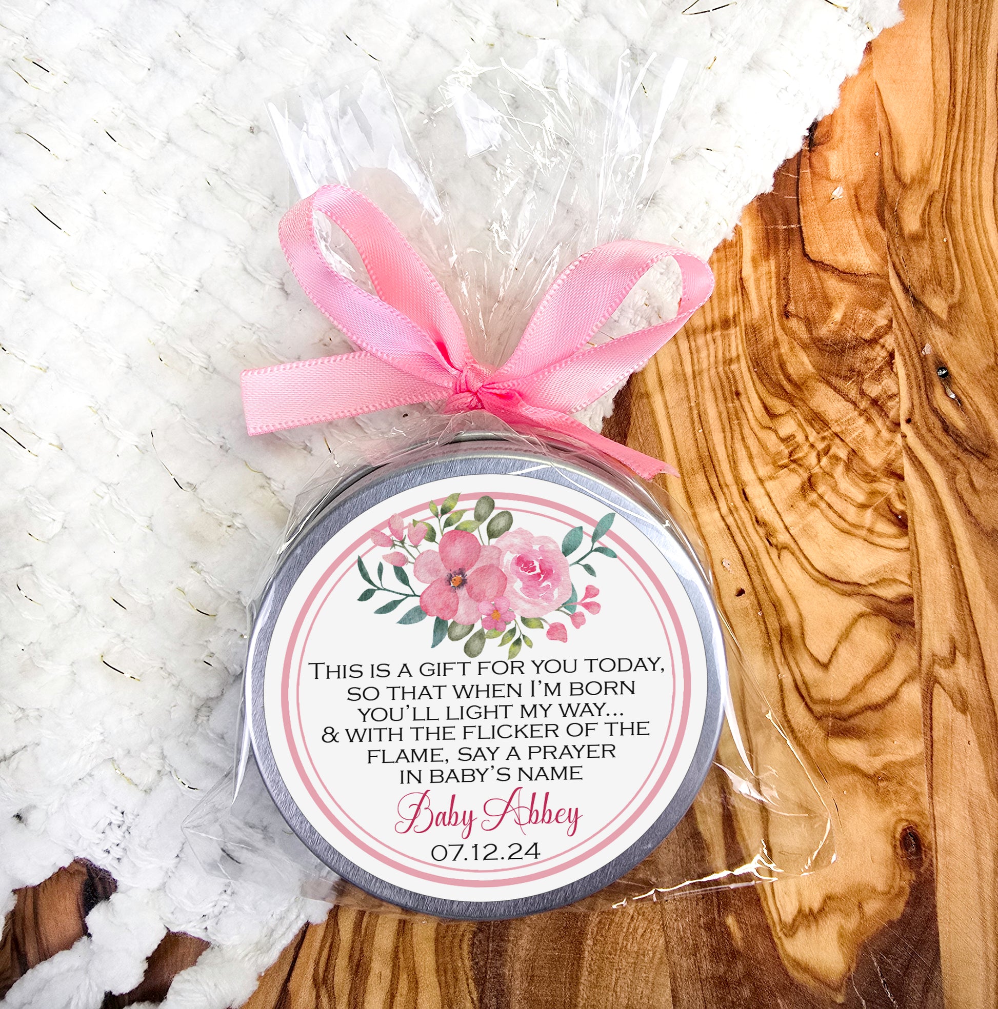 a small jar of soap with a pink ribbon
