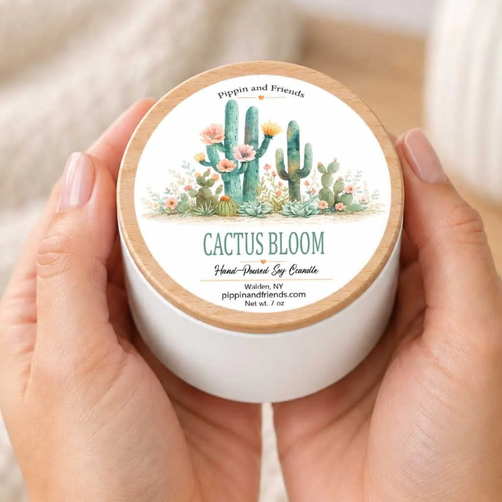 A person's hands holding a white container with a cactus design and text on it.