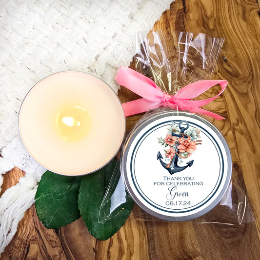 a candle next to a packaged candle on a table