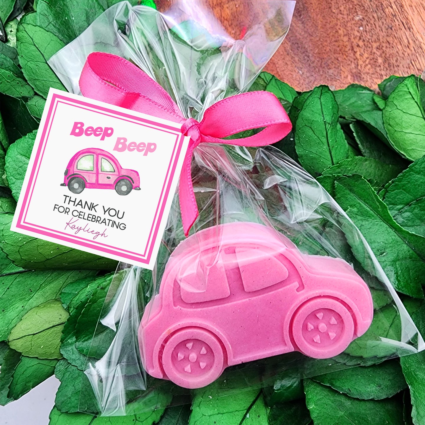 a pink car shaped soap in a cellophane bag