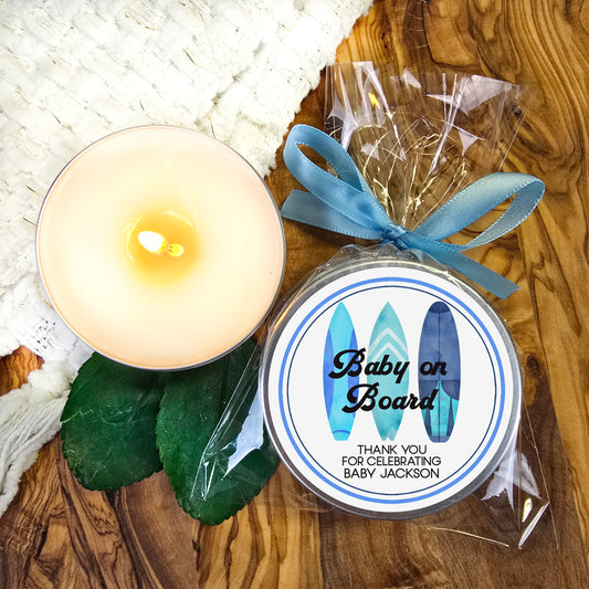 a baby on board candle next to a candle