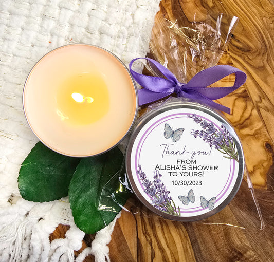 a candle with a purple ribbon next to it