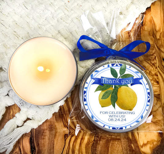 a white candle and a blue ribbon on a wooden table