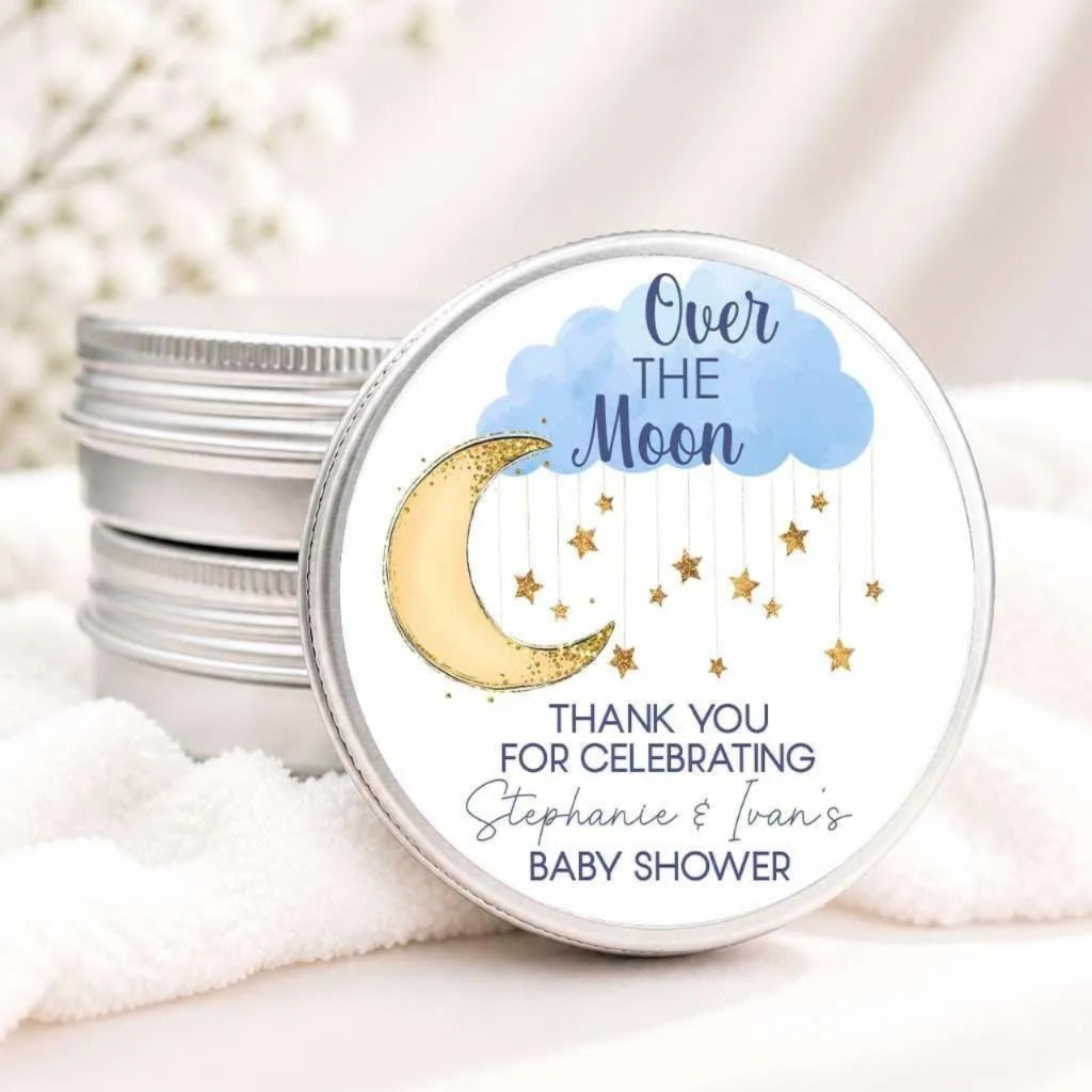 a round tin can with a label that says "Over the Moon" and "Thank you for celebrating Stephanie & Ivan's baby shower".
