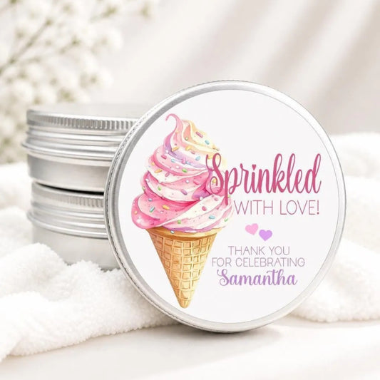 A round tin lid with a pink and white ice cream cone design and the text "Sprinkled with Love!" and "Thank you for celebrating Samantha" printed on it.