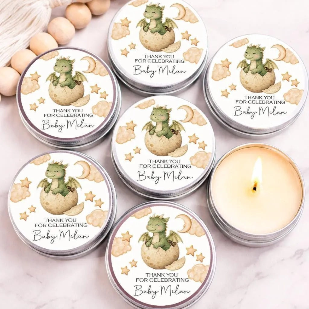 six round tin candles with a dragon design, arranged on a marble surface.