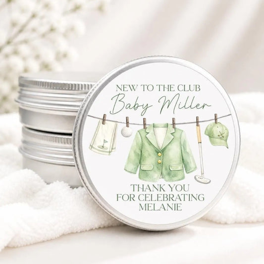 A round tin with a label that says "NEW TO THE CLUB Baby Miller" and "THANK YOU FOR CELEBRATING MELANIE".