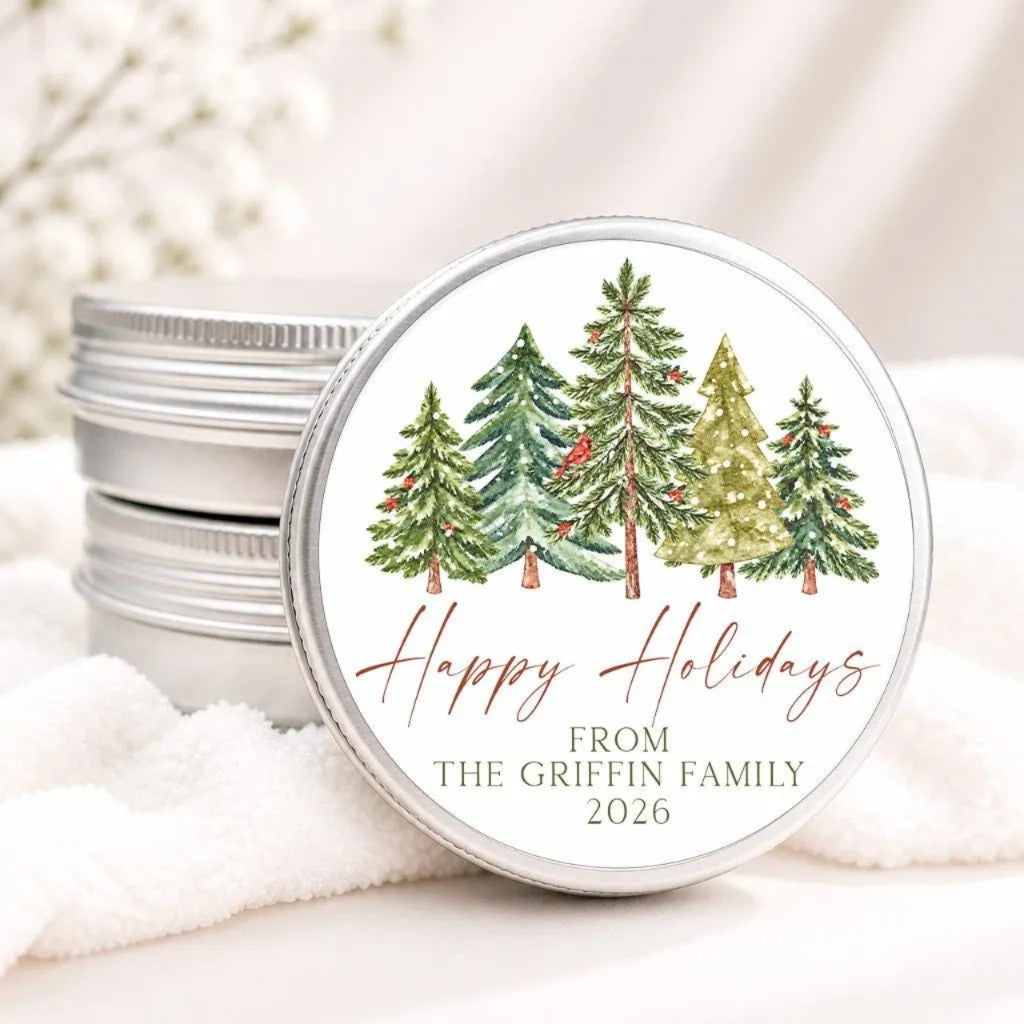A round tin lid with a festive Christmas tree design and the text "Happy Holidays from The Griffin Family 2026" printed on it.