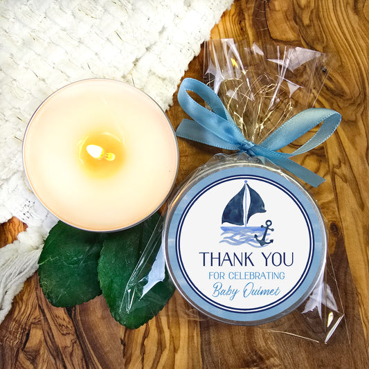 a candle and a gift bag sitting on a table