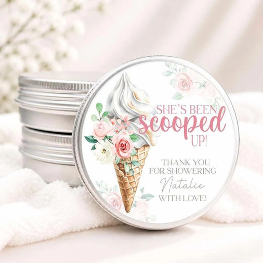 A round tin lid with a floral design and text, placed on a white cloth.