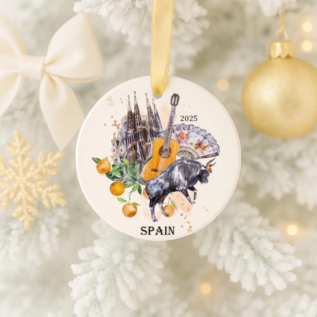 A decorative ornament hanging on a Christmas tree, featuring a bull, a guitar, and a castle, along with the text "SPAIN" and the year "2025".
