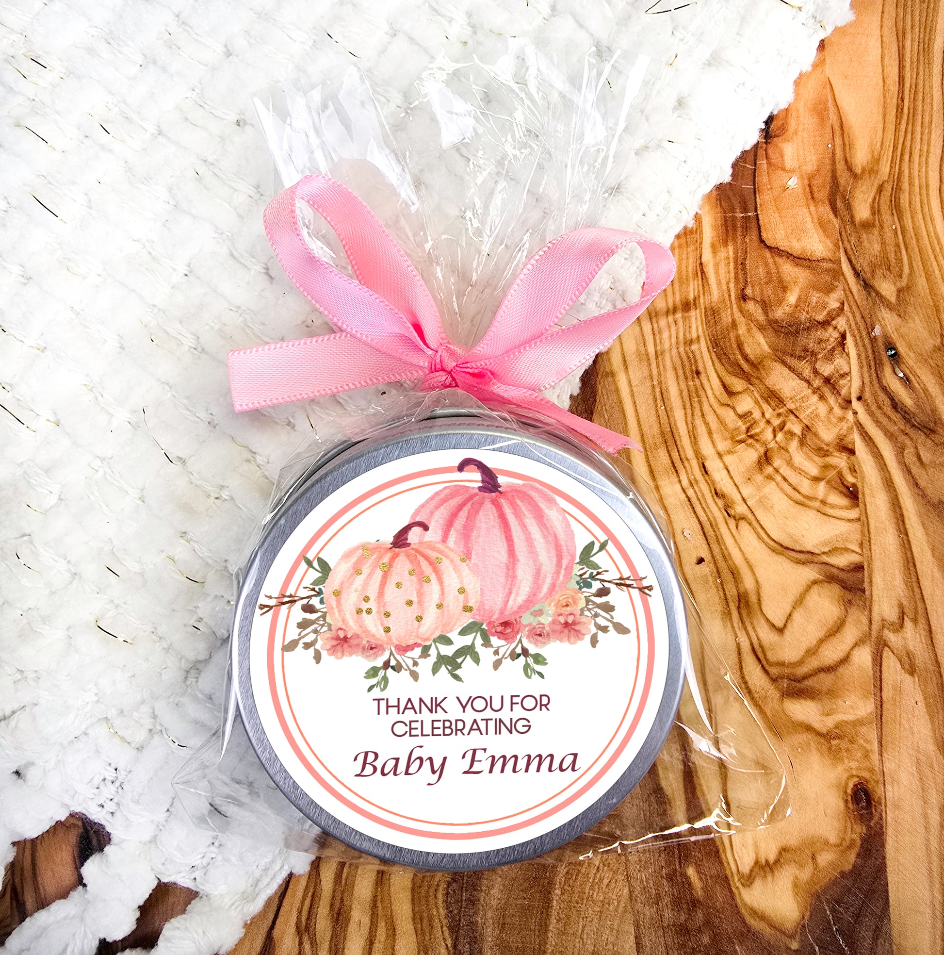 a jar of baby's first birthday candles with a pink ribbon
