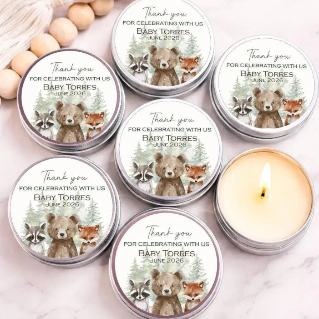 six silver tin candles with white labels, each featuring a bear and raccoon illustration and the text "