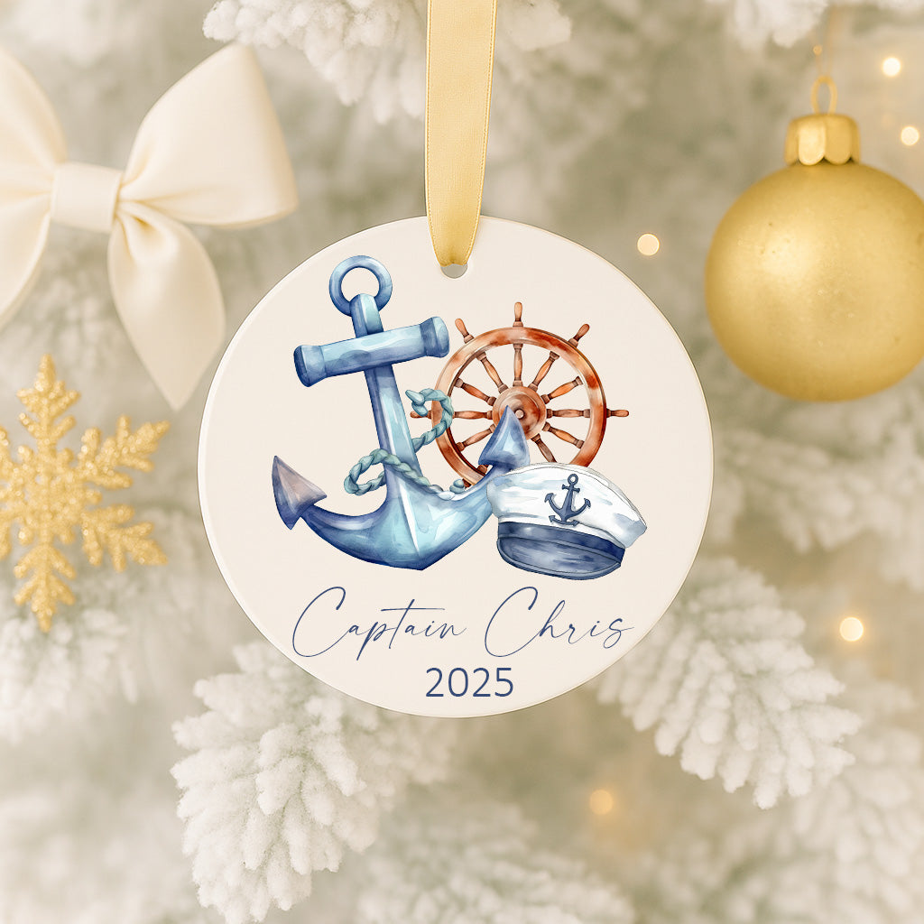 A round ornament on a Christmas tree, featuring a blue anchor, a white captain's hat, and a red steering wheel, with the text "Captain Chris" and the year "2025" printed on it.