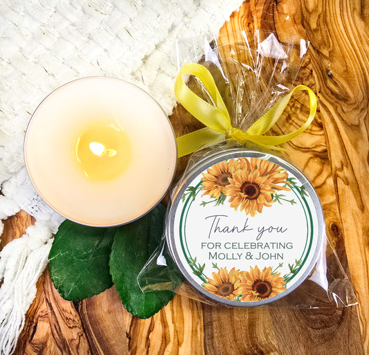 a sunflower candle and a personalized candle on a wooden table