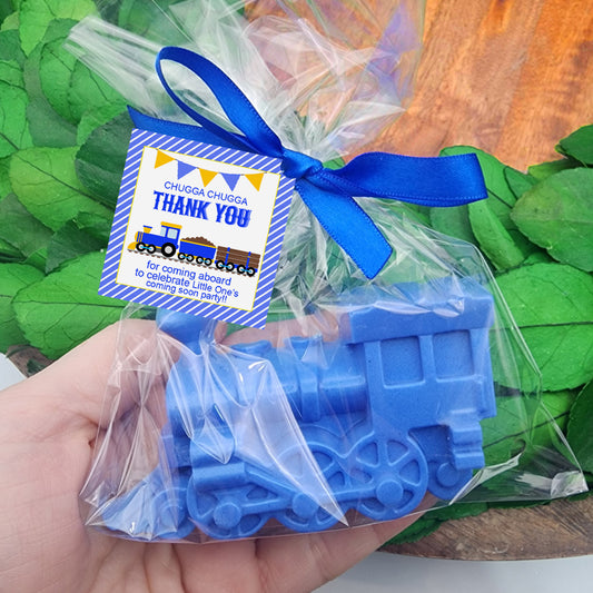a person holding a plastic train in their hand
