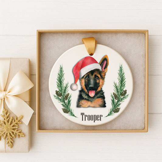 A ceramic ornament featuring a German Shepherd dog wearing a Santa hat, with the name "Trooper" written below the image.