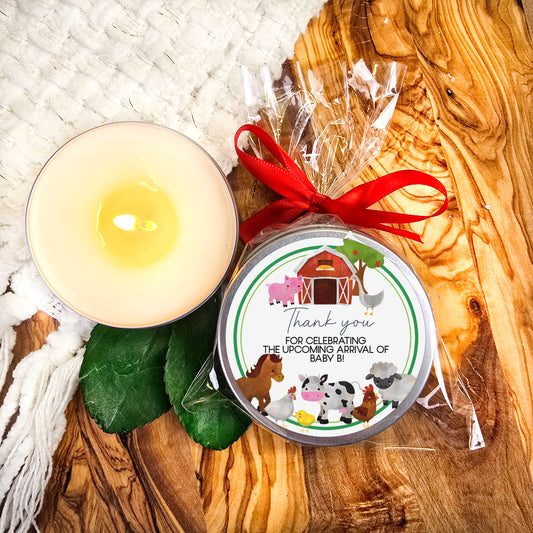 a candle and a tin of soap on a wooden table
