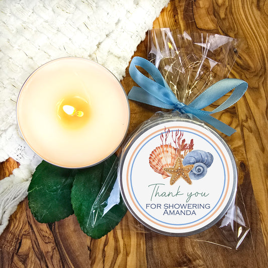 a white candle and a blue ribbon on a wooden table