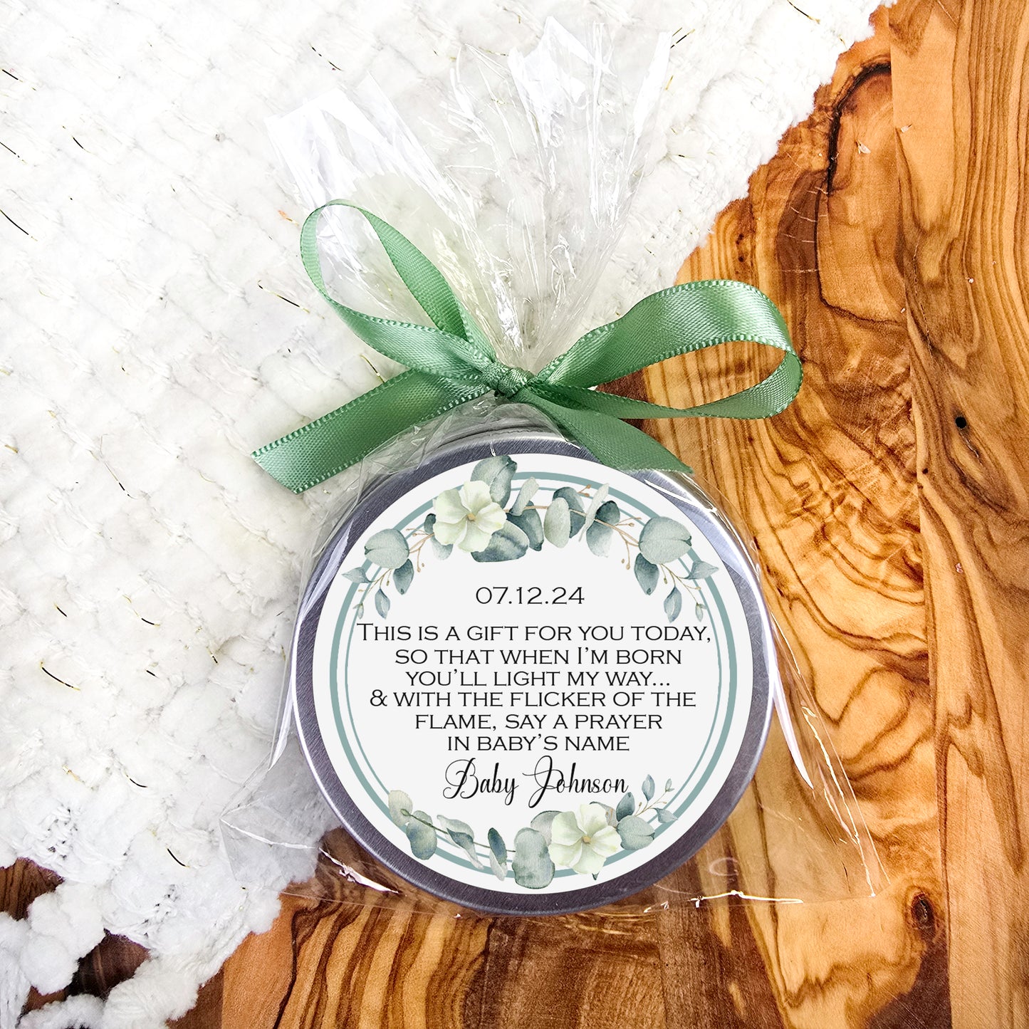 a small tin with a green ribbon on it