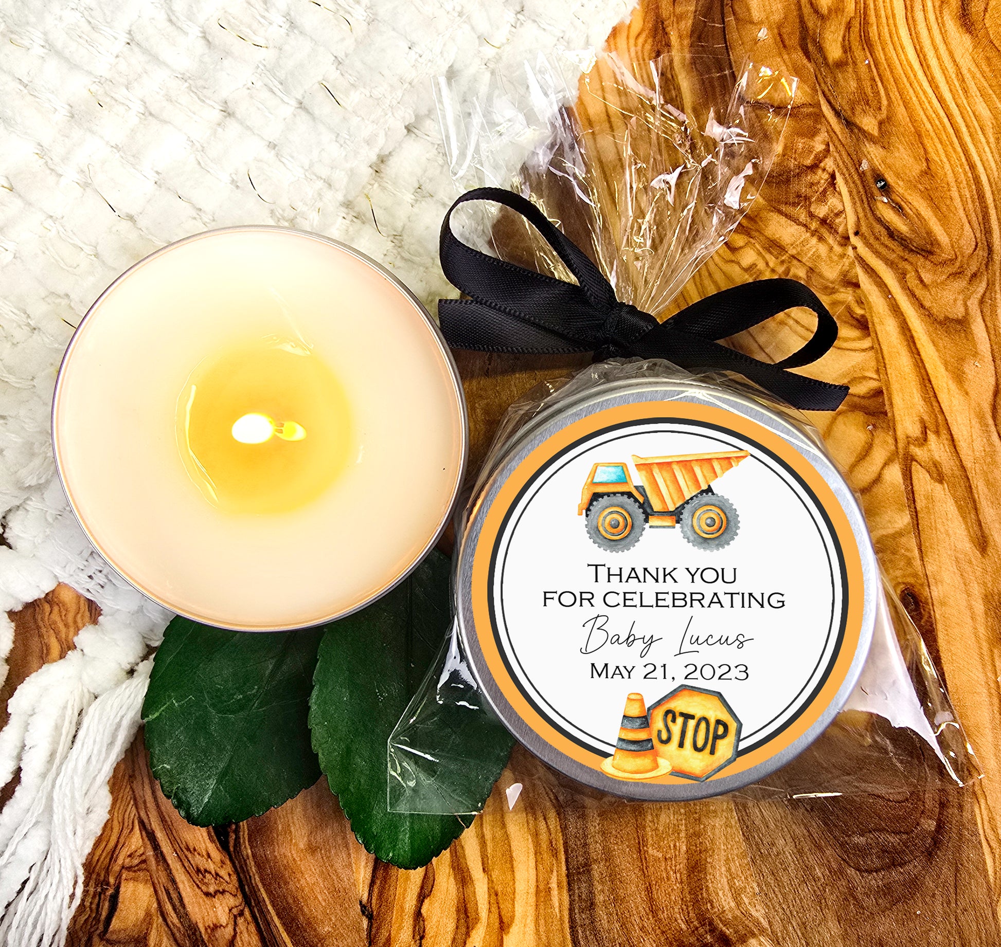 a candle and a jar of wax on a table