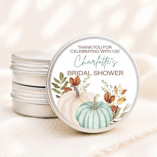 A round tin can with a label that says "Thank you for celebrating With Us! Charlotte's BRIDAL SHOWER" and features illustrations of pumpkins and autumn leaves.