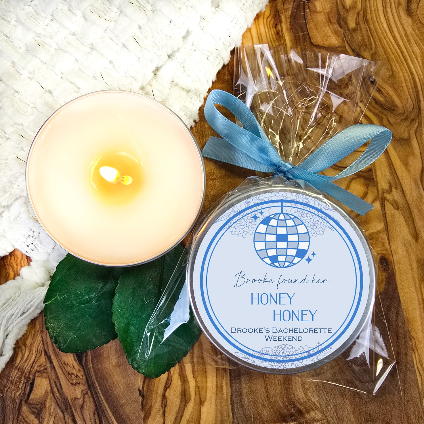 a candle and a package of honey on a table