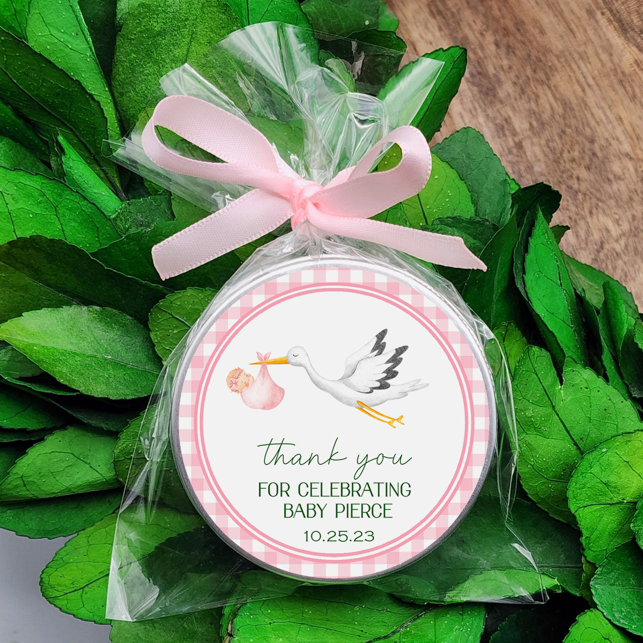 a baby shower ornament with a stork on it