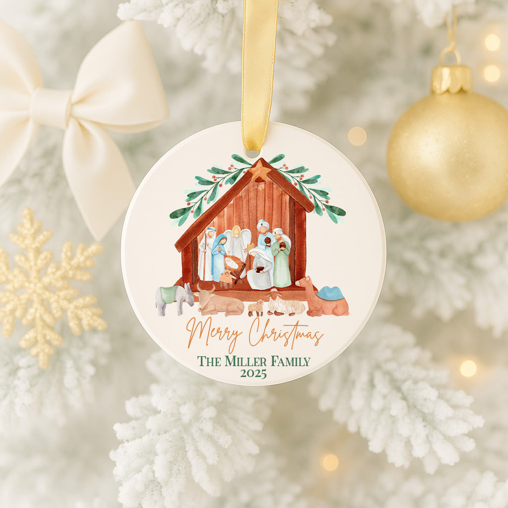 A Christmas ornament hanging on a tree, featuring a nativity scene with the text "Merry Christmas" and "The Miller Family" below it.