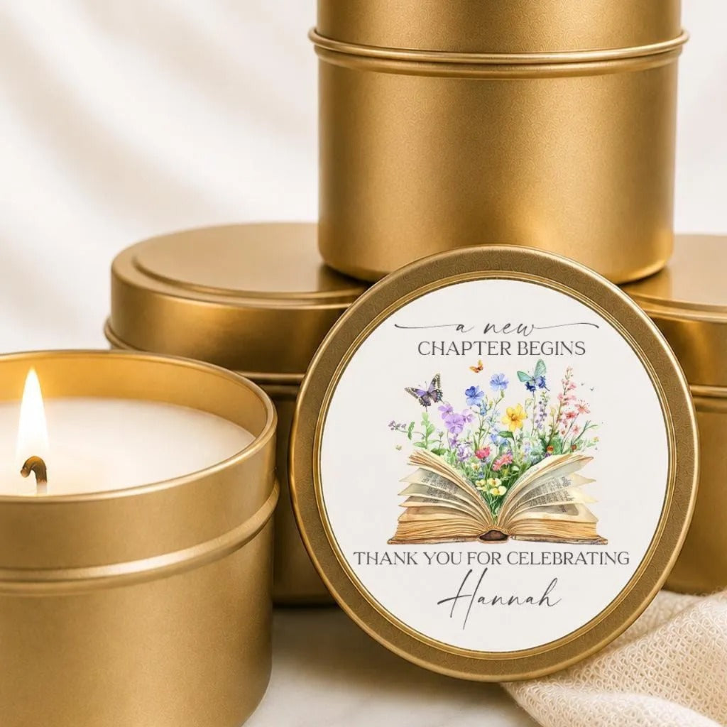 a set of golden tin candle holders with a label that reads "a new chapter begins" and "Thank you for celebrating Hannah".