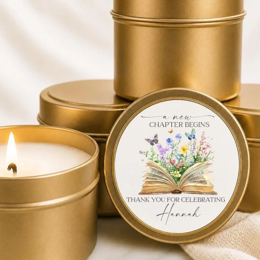 a set of golden tin candle holders with a label that reads "a new chapter begins" and "Thank you for celebrating Hannah".
