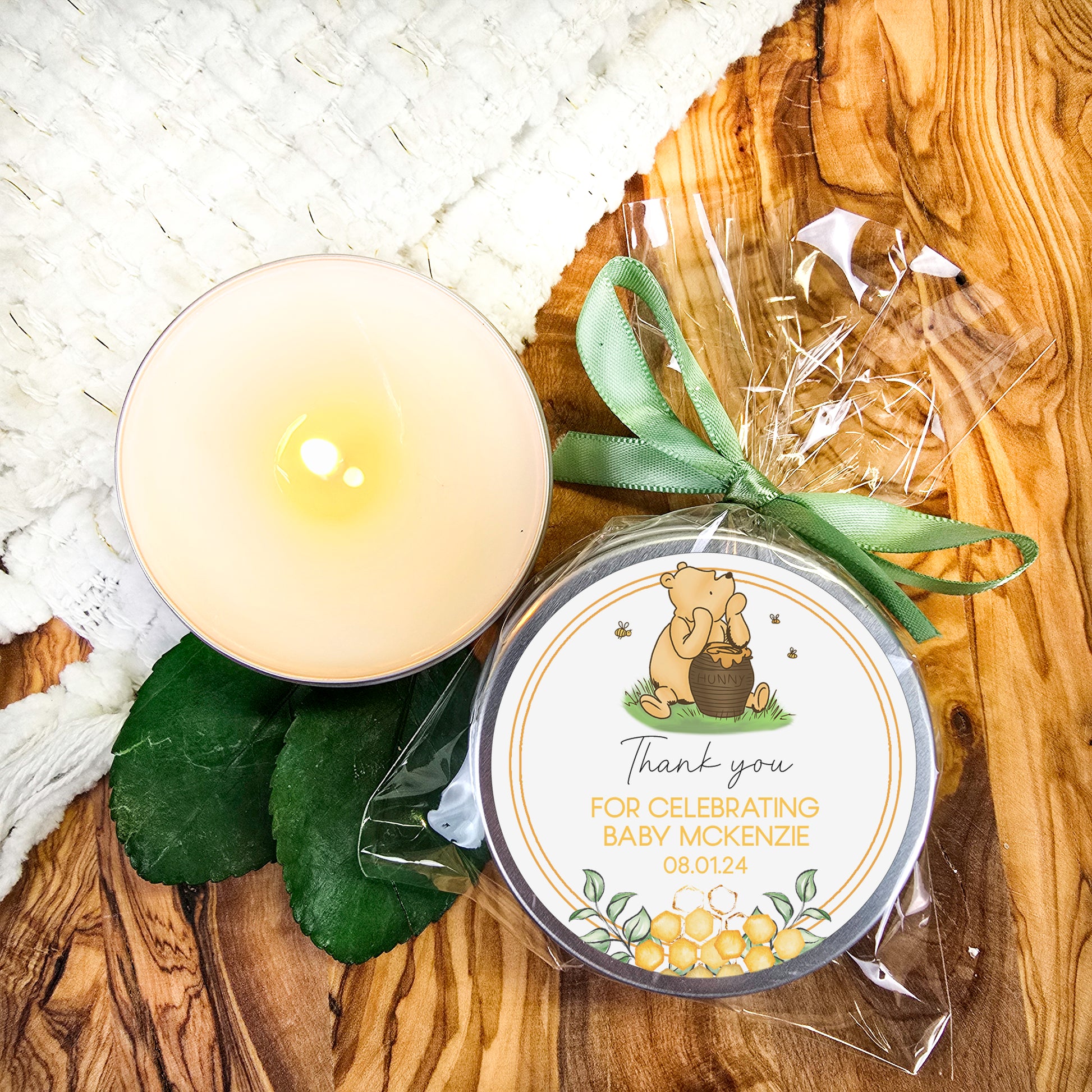 a candle sitting next to a small tin of wax