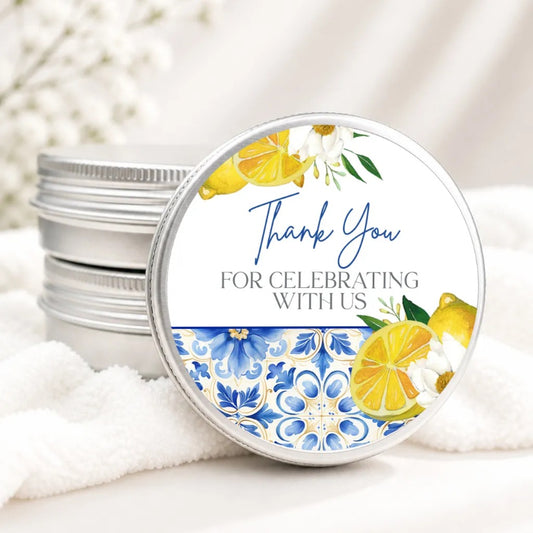 A round tin lid with a floral design and text on it, placed on a white cloth.