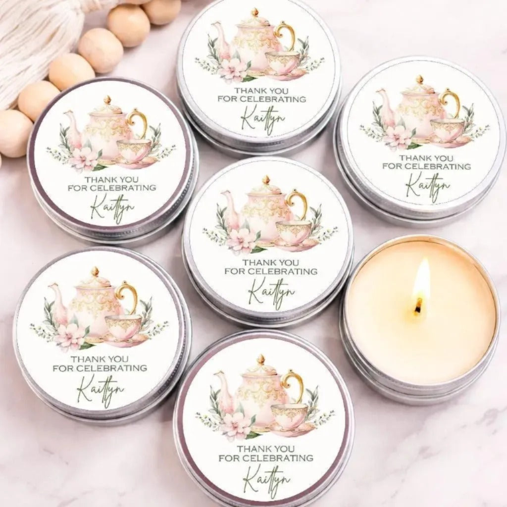 Personalized tea party candle favor with pink teapot and teacup design on silver tin candle for bridal shower or baby shower.