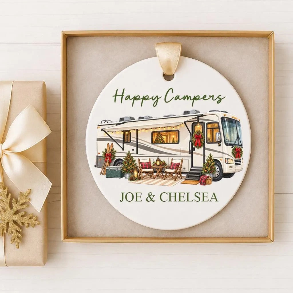 A white ceramic ornament with a picture of a recreational vehicle and holiday decorations, along with the text "Happy Campers" and "Joe & Chelsea".