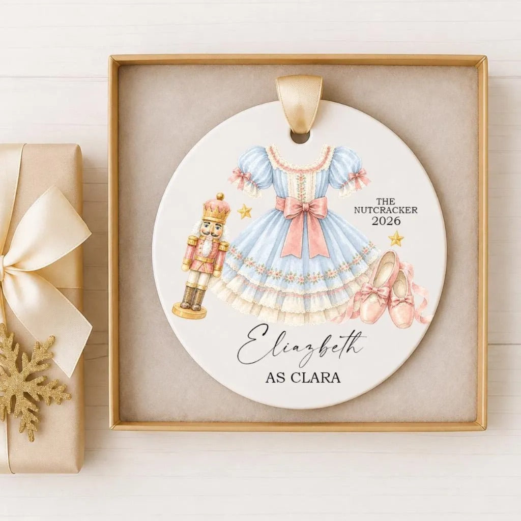 A decorative ornament featuring a nutcracker, a blue dress, and ballet slippers, with the text "The Nutcracker 2016" and "Eliza as Clara" written on it.
