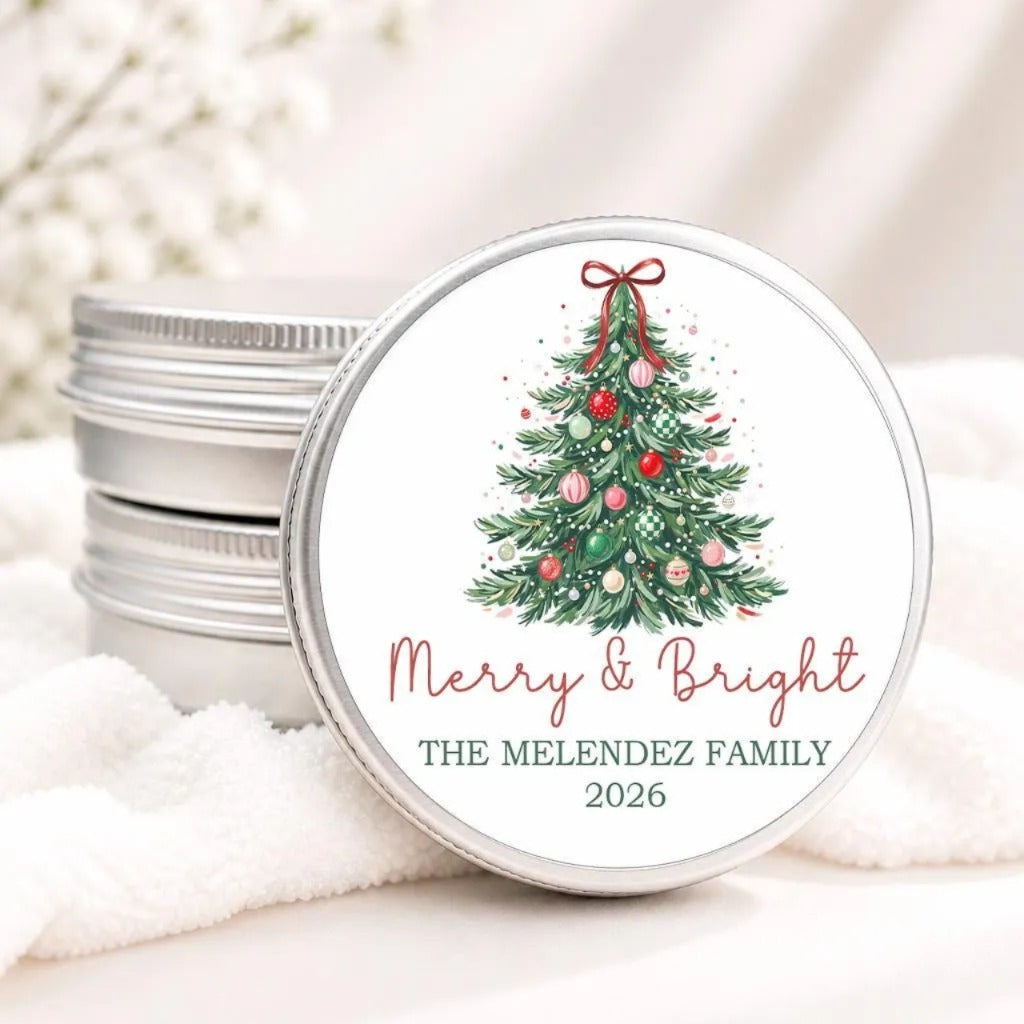 A round tin lid with a Christmas tree design and the text "Merry & Bright" and "THE MELENDZ FAMILY 2026" printed on it.