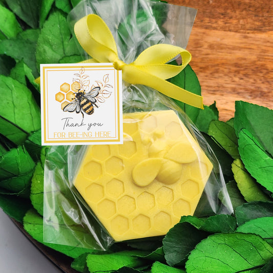 a honeycomb shaped soap bar with a yellow ribbon