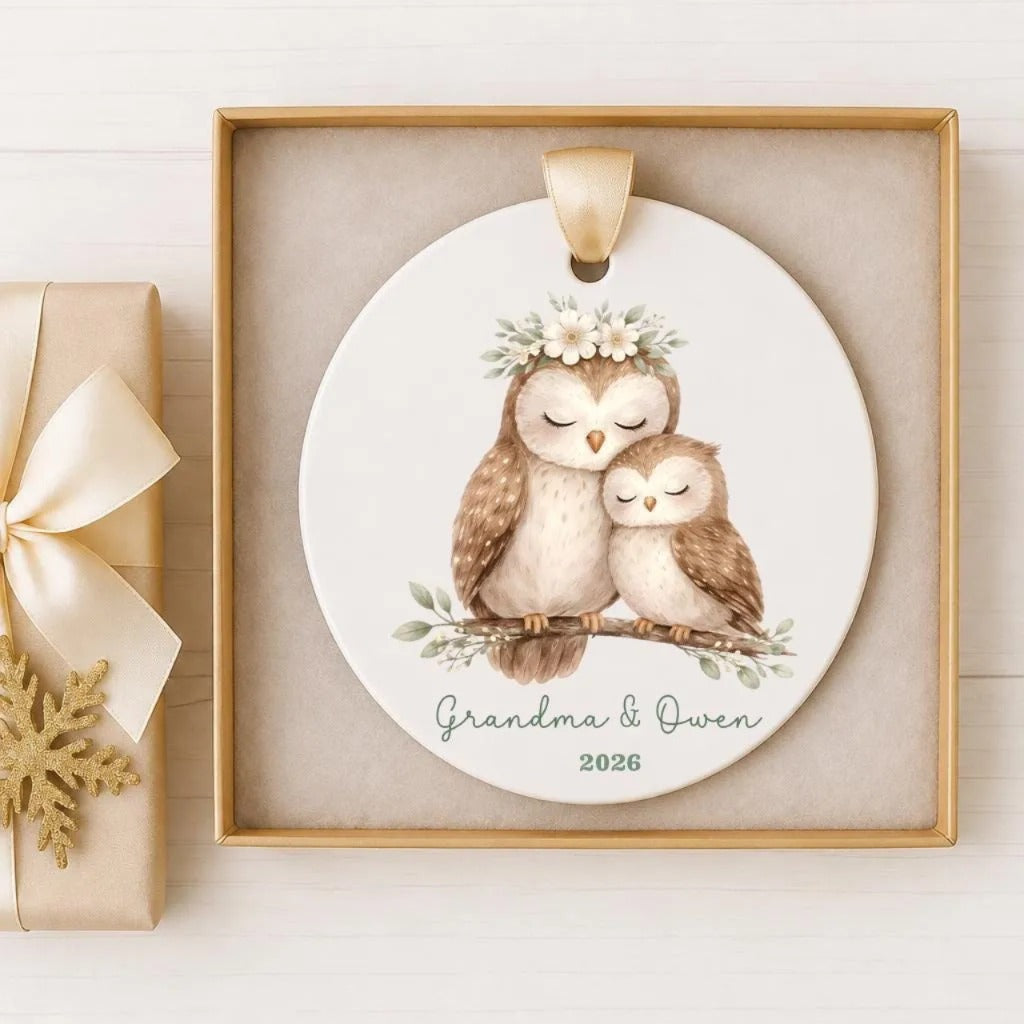 A white ceramic ornament with two owls sitting on a branch, wearing flower crowns, and the text "Grandma & Owen" and "2026" below the image.